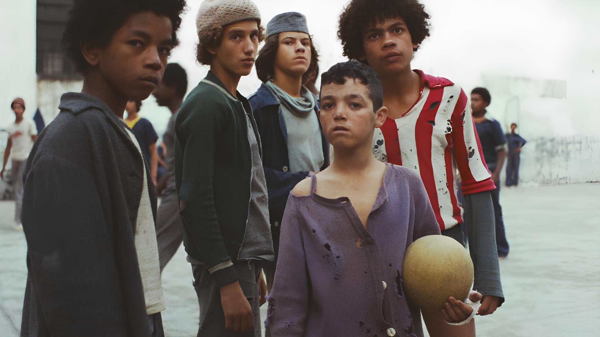 Cinematic background from Pixote 1980 - 10-year-old Pixote endures torture, degradation, and corruption at a local youth detention center where two of its members are murdered by policemen who frame Lilica, a 17-year-old trans hustler. Pixote helps Lilica and three other boys escape and they start to make their living by a life of crime which only escalates to more violence and death.