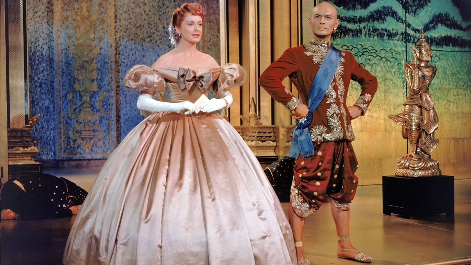 Cinematic background from The King and I 1956 - Widowed Welsh mother Anna Loenowens becomes a governess and English tutor to the wives and many children of the stubborn King Mongkut of Siam. Anna and the King have a clash of personalities as she works to teach the royal family about the English language, customs and etiquette, and rushes to prepare a party for a group of European diplomats who must change their opinions about the King.