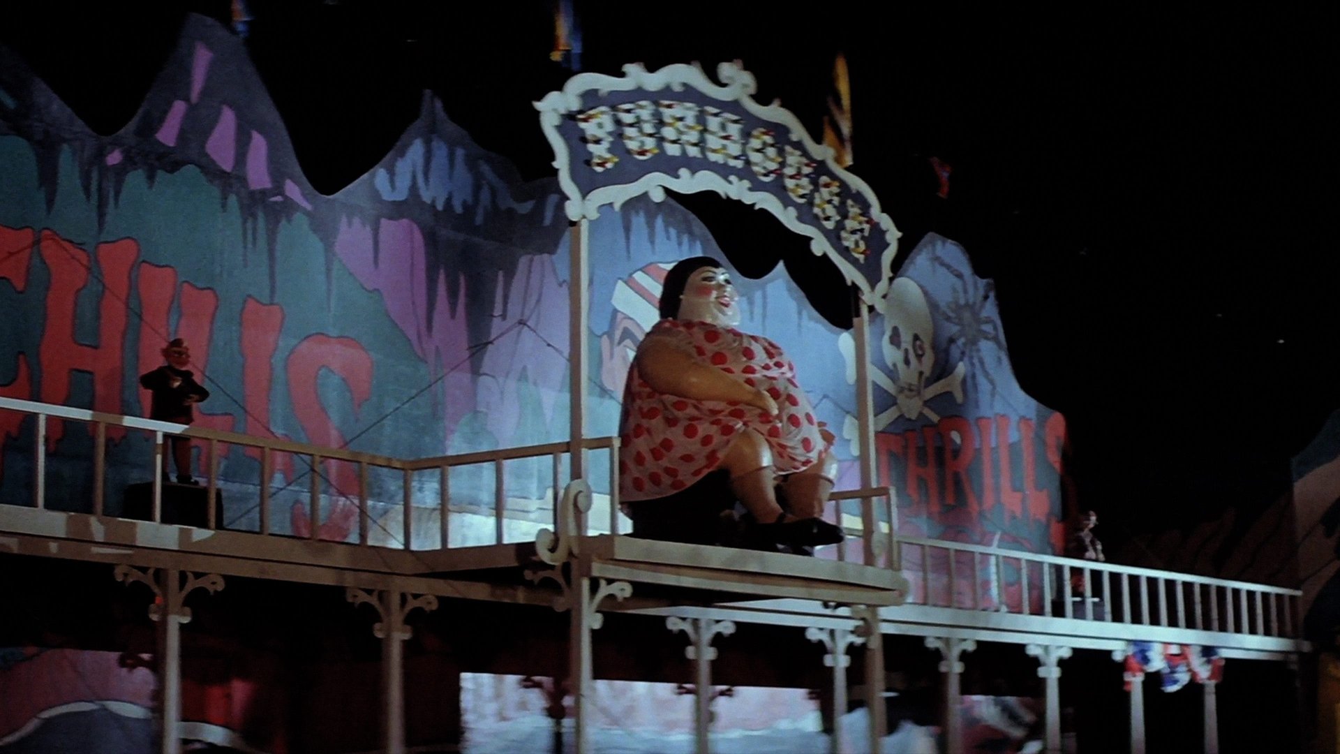 Cinematic background from The Funhouse 1981 - Rebellious teen Amy defies her parents by going to a trashy carnival that has pulled into town. In tow are her boyfriend, Buzz, and their friends Liz  and Richie. Thinking it would be fun to spend the night in the campy "Funhouse" horror ride, the teens witness a murder by a deformed worker wearing a mask. Locked in, Amy and her friends must evade the murderous carnival workers and escape before it leaves town the next day.