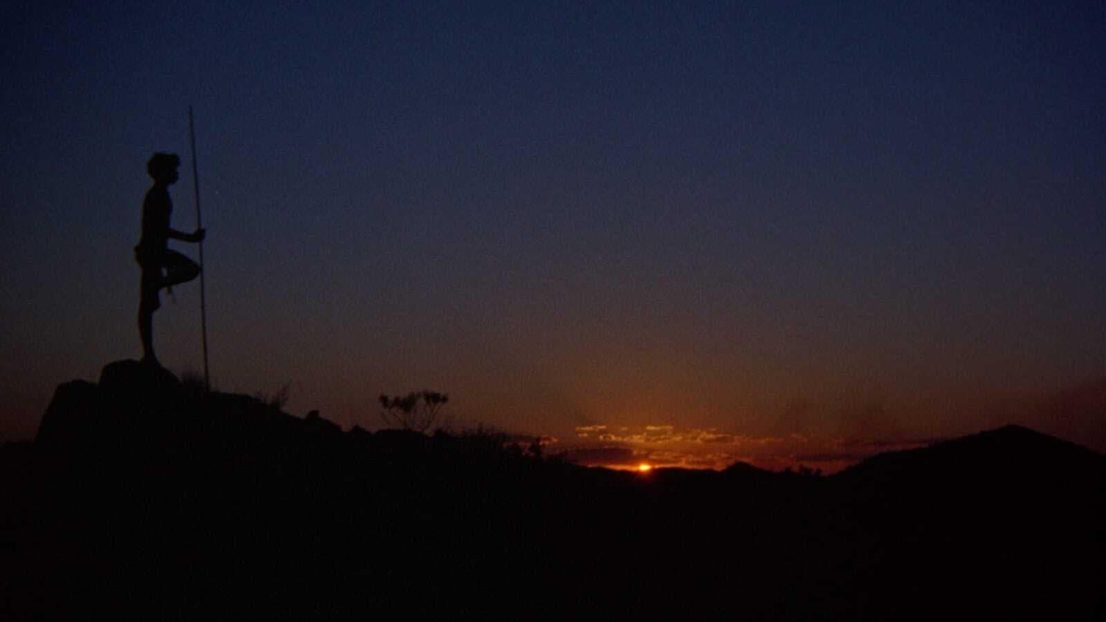 Cinematic background from Walkabout 1971 - Under the pretense of having a picnic, a geologist takes his teenage daughter and 6-year-old son into the Australian outback and attempts to shoot them. When he fails, he turns the gun on himself, and the two city-bred children must contend with harsh wilderness alone. They are saved by a chance encounter with an Aboriginal boy who shows them how to survive, and in the process underscores the disharmony between nature and modern life.