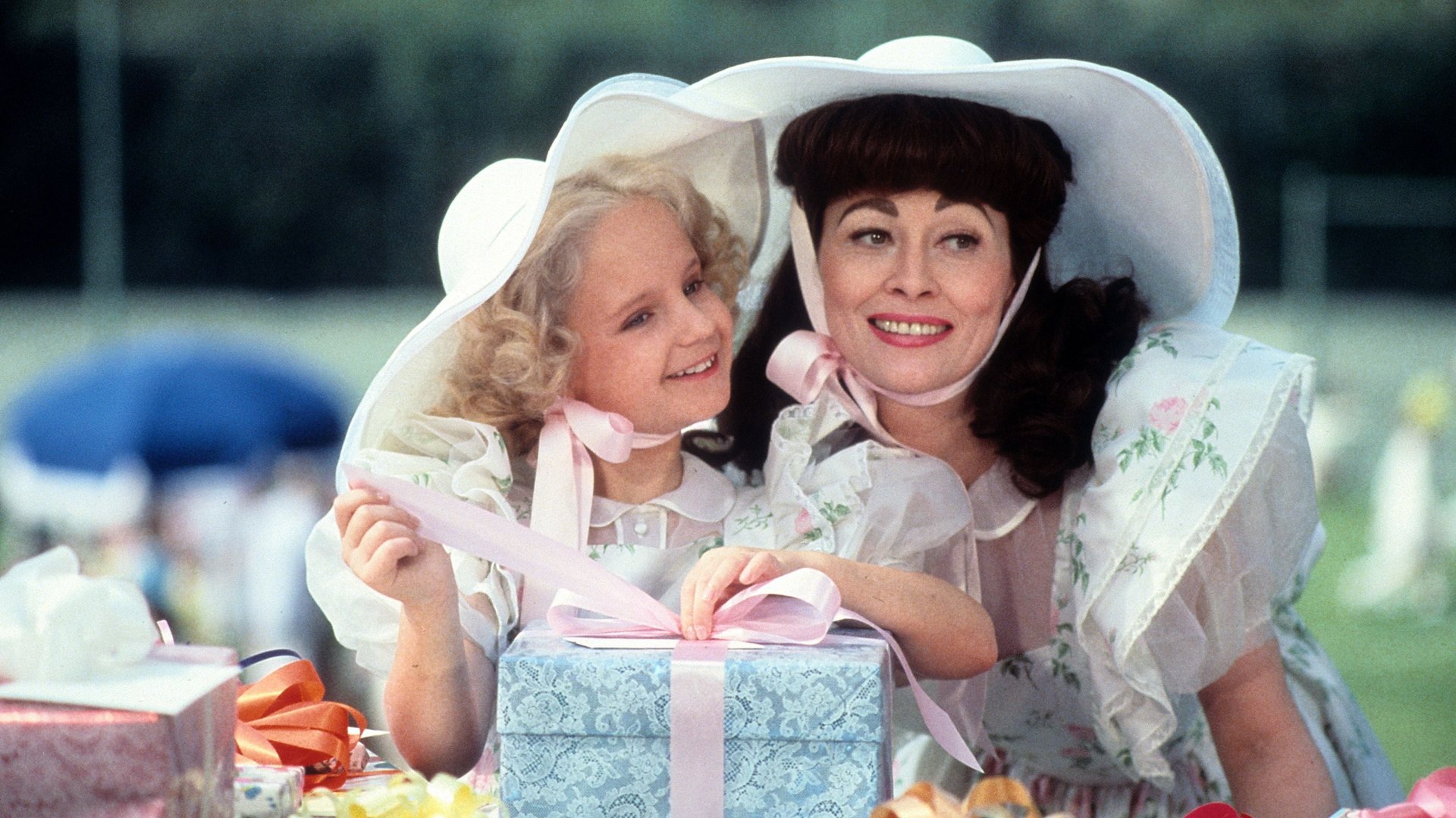 Cinematic background from Mommie Dearest 1981 - Renowned actress Joan Crawford, at the height of her career, adopts two orphans — Christina and Christopher — to fill the lonely gap in her personal life. However, as her professional and romantic relationships sour, Joan's already callous and abusive behavior towards Christina intensifies. Christina leaves home to pursue an acting path of her own, only to find her mother's presence still overshadowing her.