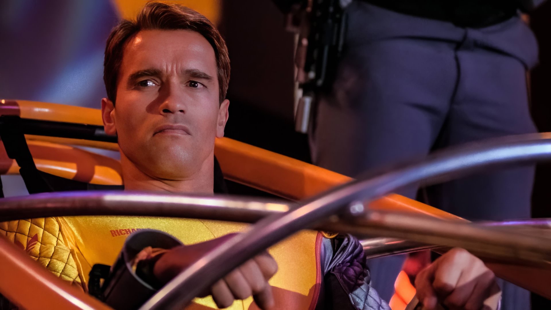 Cinematic background from The Running Man 1987 - By 2017, the global economy has collapsed and U.S. society has become a totalitarian police state, censoring all cultural activity. The government pacifies the populace by broadcasting a number of game shows in which convicted criminals fight for their lives, including the gladiator-style The Running Man, hosted by the ruthless Damon Killian, where “runners” attempt to evade “stalkers” and certain death for a chance to be pardoned and set free.