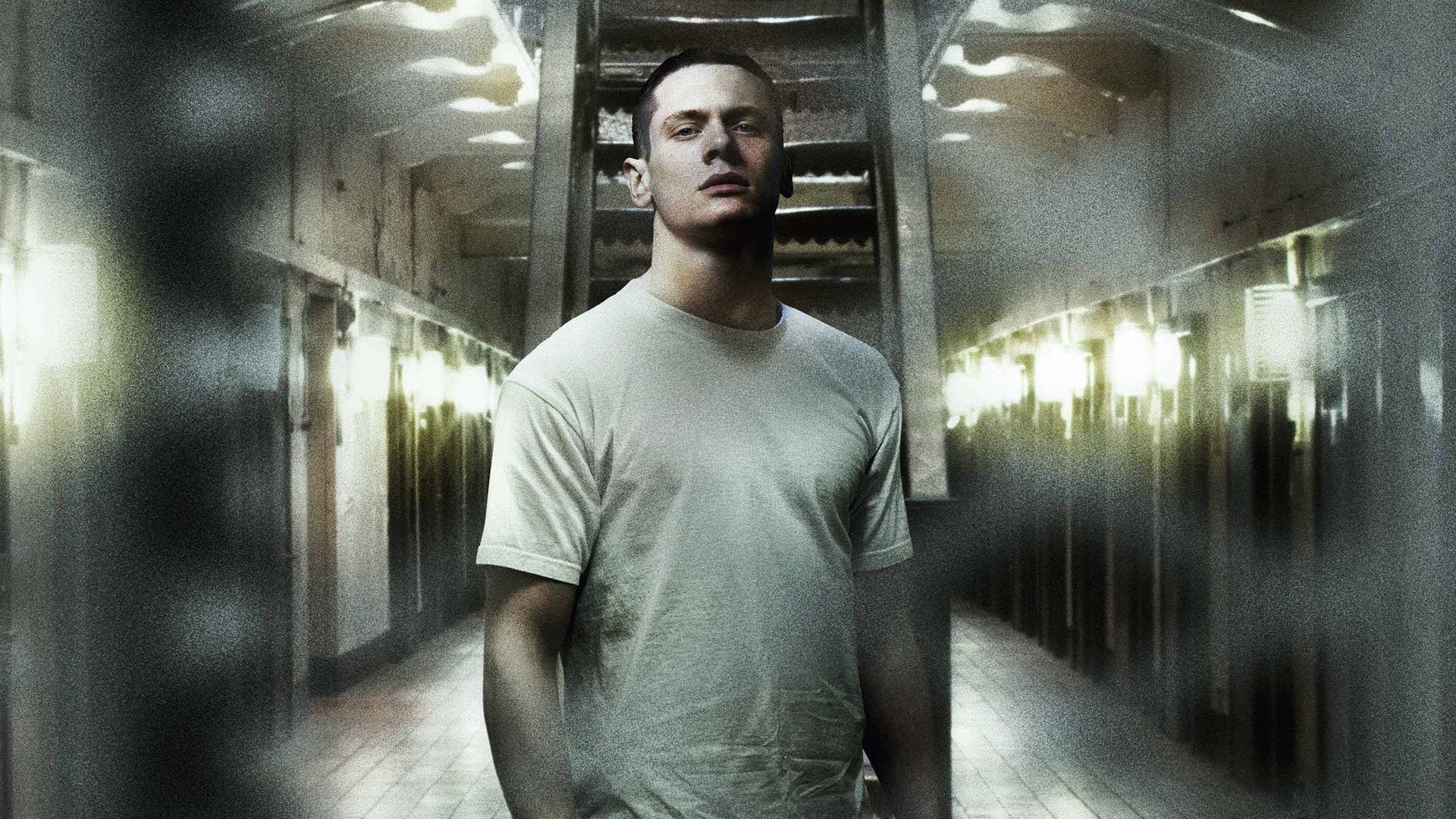 Cinematic background from Starred Up 2013 - 19-year-old Eric, arrogant and ultra-violent, is prematurely transferred to the same adult prison facility as his estranged father. As his explosive temper quickly finds him enemies in both prison authorities and fellow inmates — and his already volatile relationship with his father is pushed past breaking point — Eric is approached by a volunteer psychotherapist, who runs an anger management group for prisoners. Torn between gang politics, prison corruption, and a glimmer of something better, Eric finds himself in a fight for his own life, unsure if his own father is there to protect him or join in punishing him.