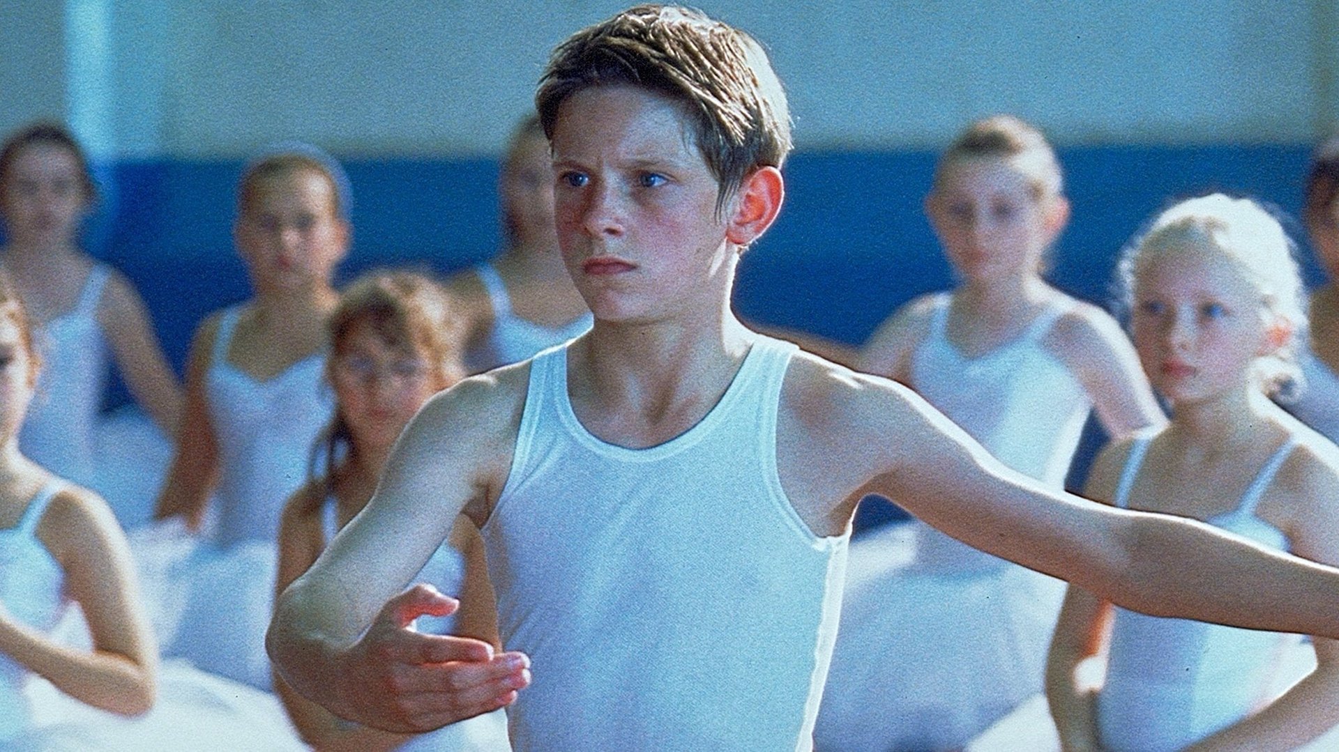 Cinematic background from Billy Elliot 2000 - County Durham, England, 1984. The miners' strike has started and the police have started coming up from Bethnal Green, starting a class war with the lower classes suffering. Caught in the middle of the conflict is 11-year old Billy Elliot, who, after leaving his boxing club for the day, stumbles upon a ballet class and finds out that he's naturally talented. He practices with his teacher Mrs. Wilkinson for an upcoming audition in Newcastle-upon Tyne for the royal Ballet school in London.