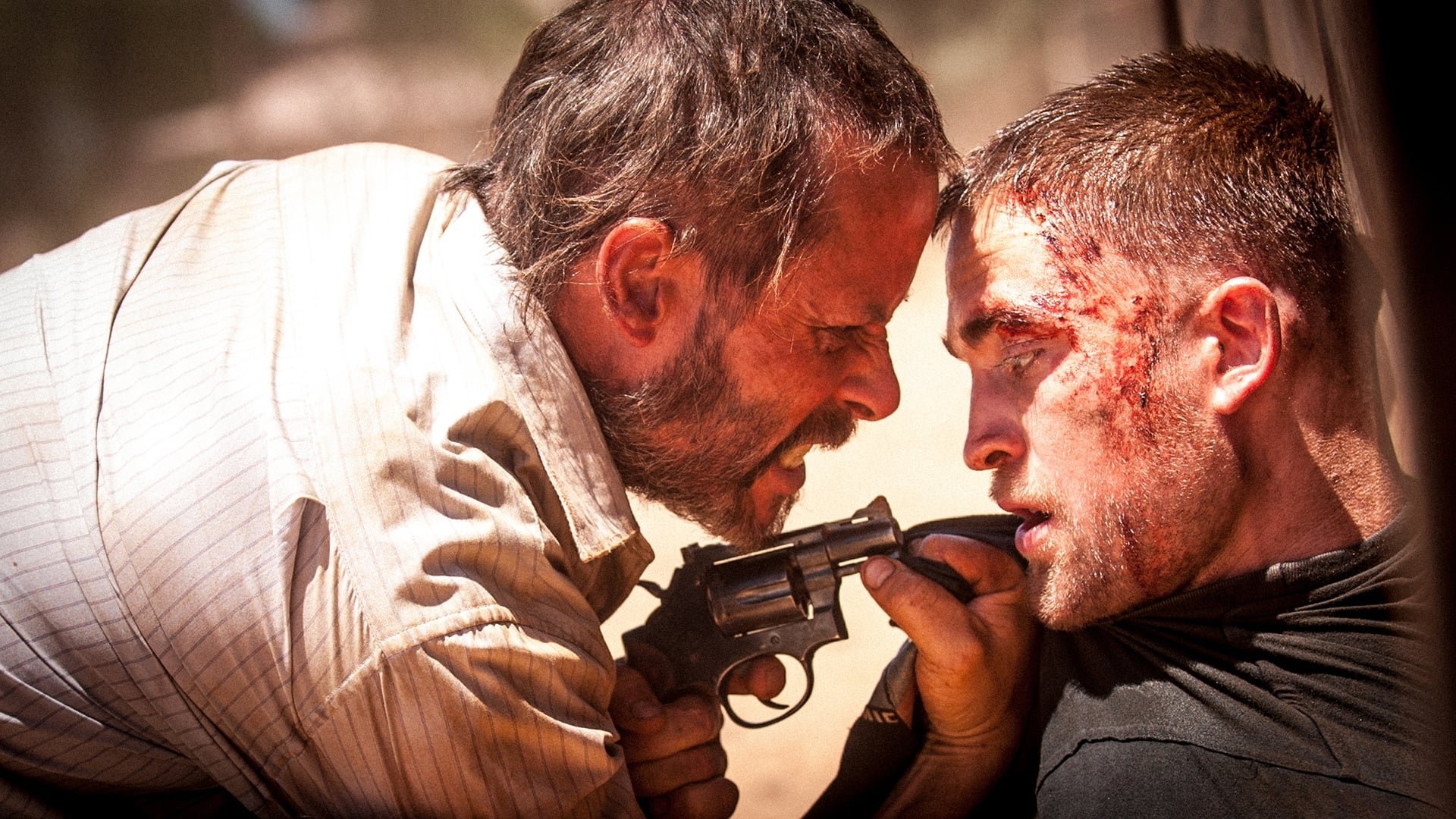 Cinematic background from The Rover 2014 - 10 years after a global economic collapse, a hardened loner pursues the men who stole his car through the lawless wasteland of the Australian outback, aided by the brother of one of the thieves.