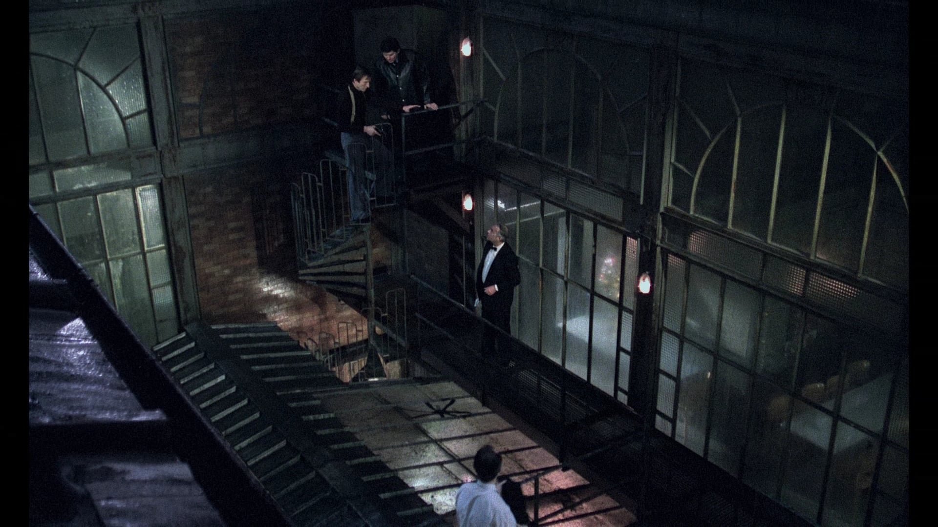 Cinematic background from The Grilling 1981 - Martinaud, an illustrious notary suspected of being the perpetrator of two horrendous crimes, voluntarily agrees to be questioned by Inspector Gallien on New Year's Eve. What initially is a routine procedure, soon becomes a harsh interrogation that seems to confirm the initial suspicions.