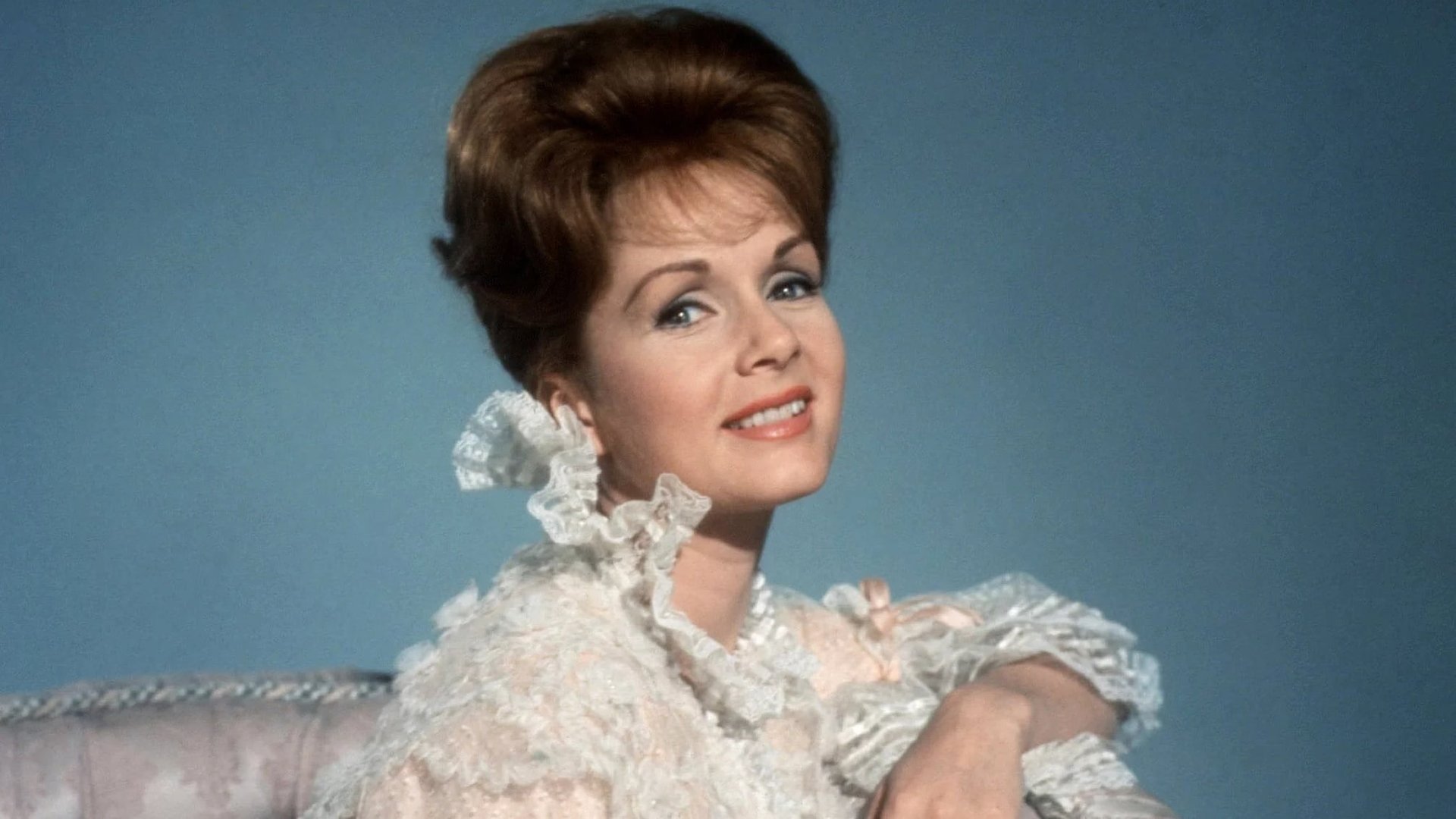 Cinematic background from The Unsinkable Molly Brown 1964 - The buoyant Molly Brown has survived the first crisis of her life—a flood. Sixteen years later she sets out to make her way in the world. She assures the Leadville saloon keeper that she can sing and play the piano, and learns quickly. Soon she marries Johnny Brown, who in a few years will be able to replace the original cigar wrapper wedding ring with a replica in gold and gemstones. The Browns head for Europe and bring a few crowned heads back to Denver for a party that turns into a ballroom brawl. Molly goes to Europe alone, returning on the Titanic. She didn't survive a flood as a baby for the story to end here.