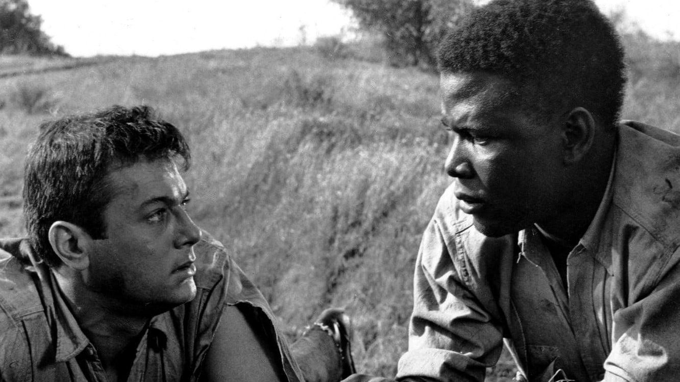Cinematic background from The Defiant Ones 1958 - Two convicts—a white racist and an angry black man—escape while chained to each other.