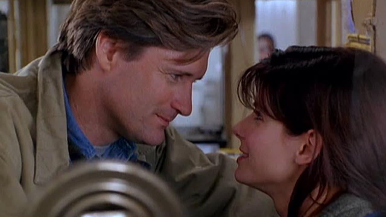 Cinematic background from While You Were Sleeping 1995 - A transit worker pulls commuter Peter off railway tracks after he's mugged, but—while he's in a coma—his family mistakenly thinks she's Peter's fiancée, and she doesn't correct them. Things get more complicated when she falls for his brother, who's not quite sure that she's who she claims to be.