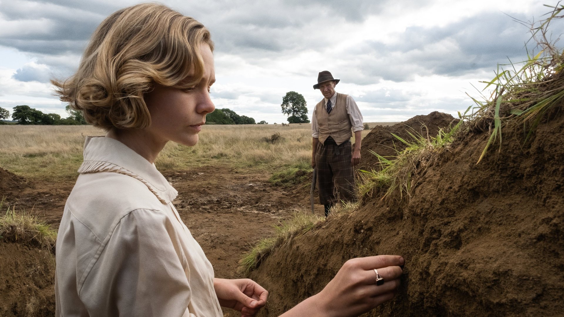 Cinematic background from The Dig 2021 - As WWII looms, a wealthy widow hires an amateur archaeologist to excavate the burial mounds on her estate. When they make a historic discovery, the echoes of Britain's past resonate in the face of its uncertain future‎.