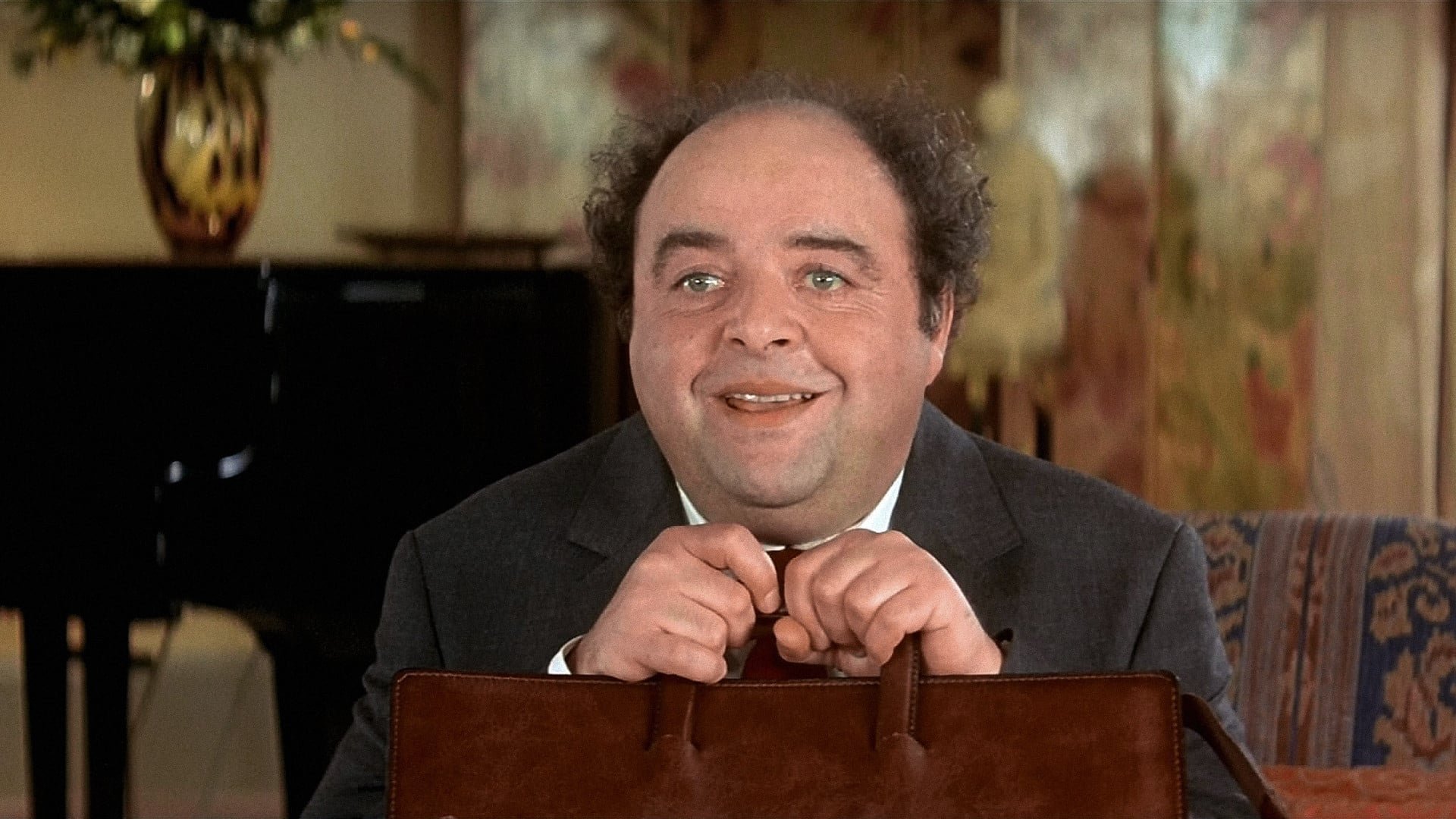 Cinematic background from Le Dîner de Cons 1998 - For Pierre Brochant and his friends, Wednesday is “Idiots' Day”. The idea is simple: each person has to bring along an idiot. The one who brings the most spectacular idiot wins the prize. Tonight, Brochant is ecstatic. He has found a gem. The ultimate idiot, “A world champion idiot!”. What Brochant doesn’t know is that Pignon is a real jinx, a past master in the art of bringing on catastrophes...