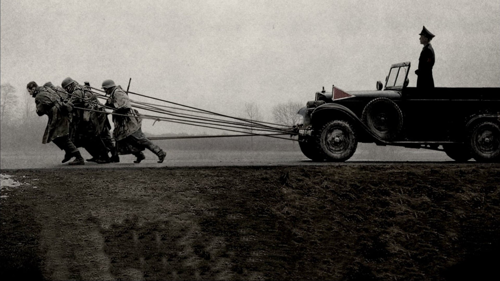 Cinematic background from The Captain 2017 - Germany, 1945. Soldier Willi Herold, a deserter of the German army, stumbles into a uniform of Nazi captain abandoned during the last and desperate weeks of the Third Reich. Newly emboldened by the allure of a suit that he has stolen only to stay warm, Willi discovers that many Germans will follow the leader, whoever he is.