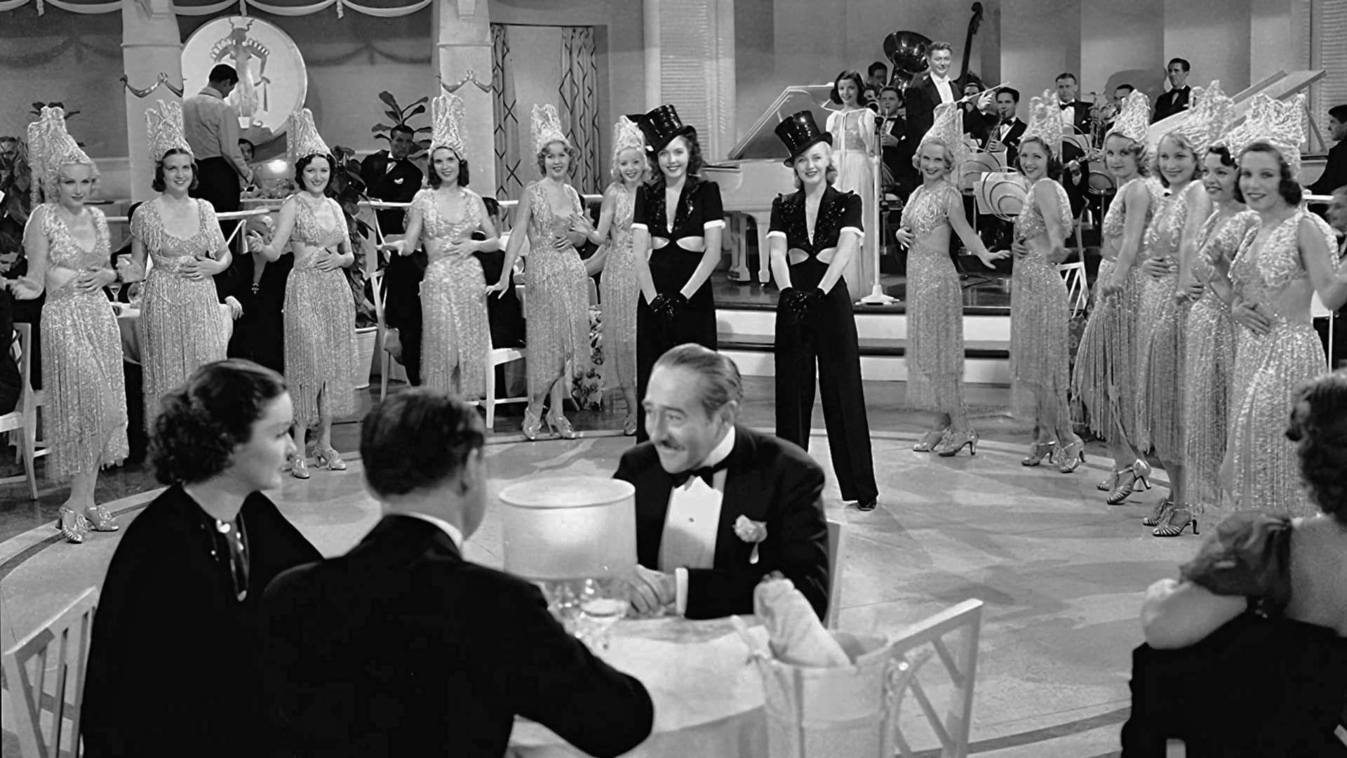 Cinematic background from Stage Door 1937 - The ups and downs in the lives and careers of a group of ambitious young actresses and show girls from disparate backgrounds brought together in a theatrical hostel. Centres particularly on the conflict and growing friendship between Terry Randall, a rich girl confident in her talent and ability to make it to the top on the stage, and Jean Maitland, a world weary and cynical trouper who has taken the hard knocks of the ruthless and over-populated world of the Broadway apprentice.