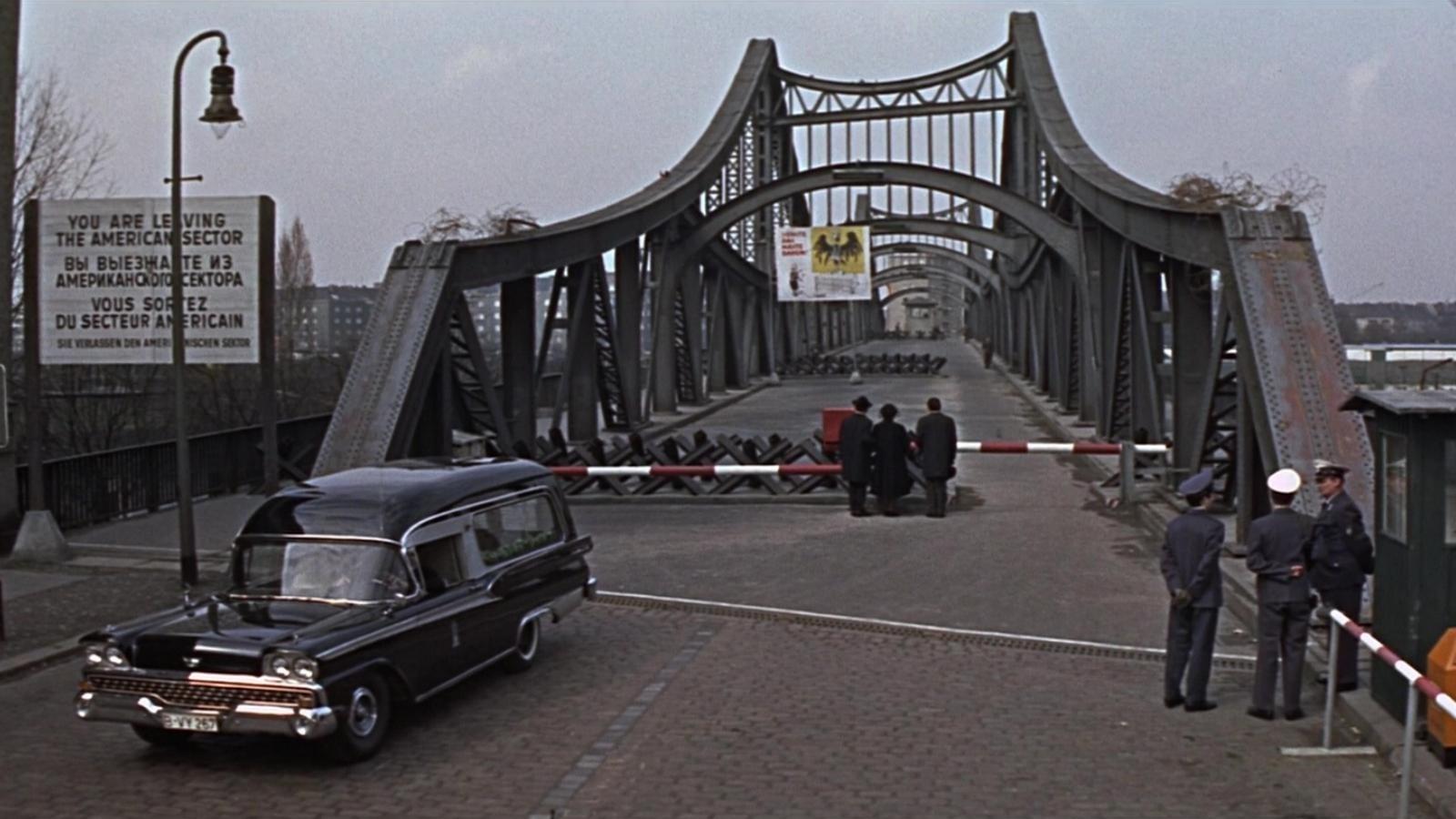 Cinematic background from Funeral in Berlin 1966 - Colonel Stok, a Soviet intelligence officer responsible for security at the Berlin Wall, appears to want to defect but the evidence is contradictory. Stok wants the British to handle his defection and asks for one of their agents, Harry Palmer, to smuggle him out of East Germany.