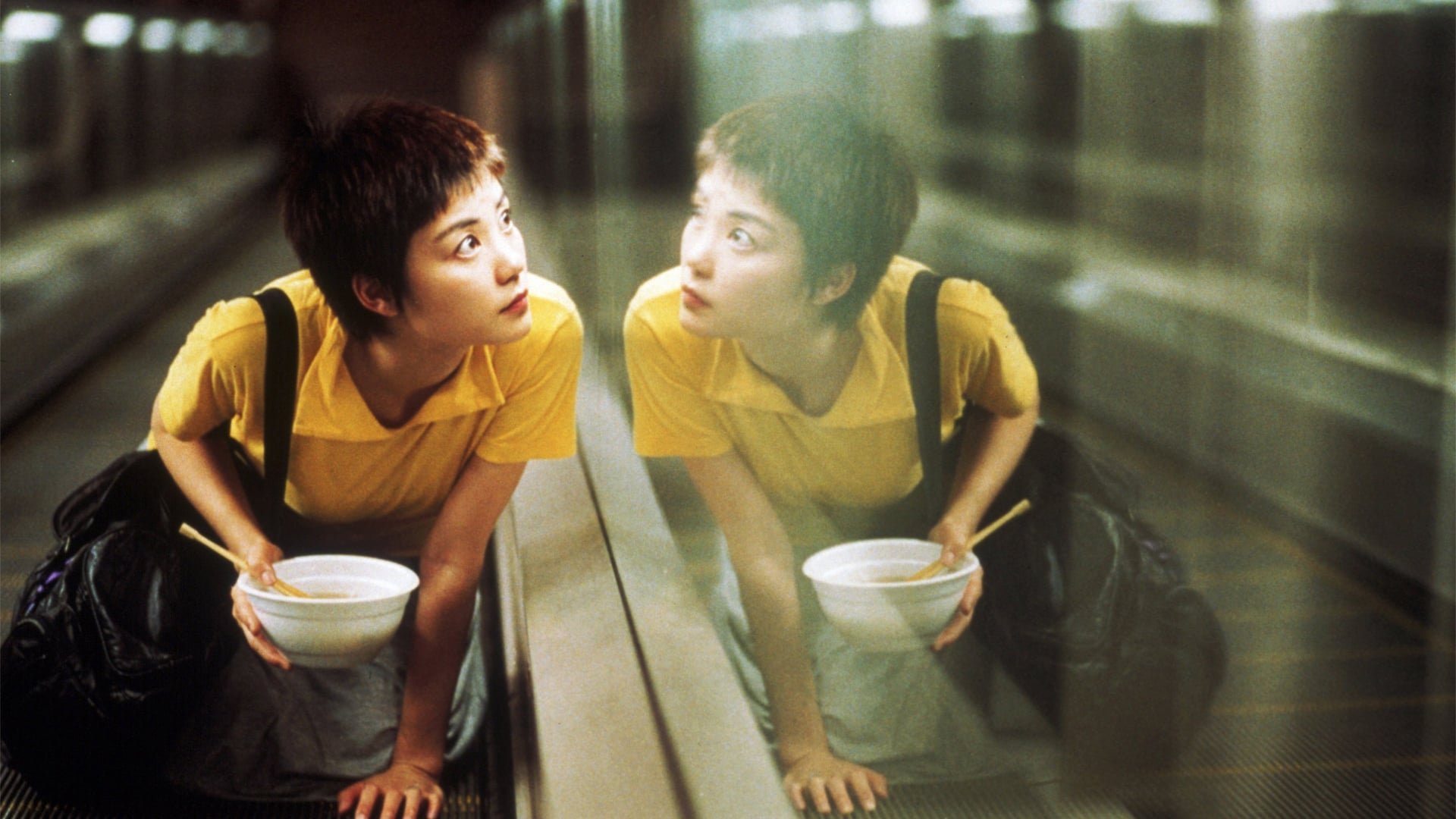 Cinematic background from Chungking Express 1994 - Two melancholic Hong Kong policemen fall in love: one with a mysterious underworld figure, the other with a beautiful and ethereal server at a late-night restaurant.