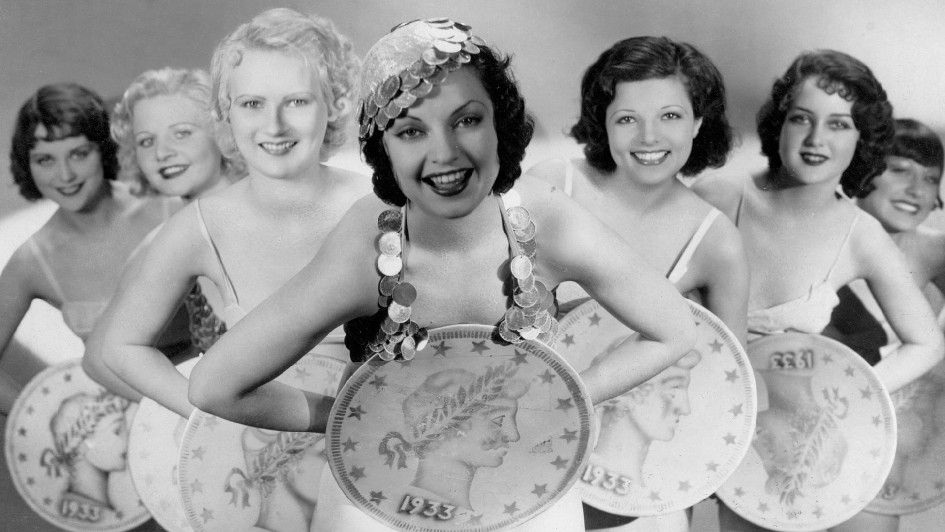 Cinematic background from Gold Diggers of 1933 1933 - Things get tough for Carol and her showgirl pals, Trixie and Polly, when the Great Depression kicks in and all the Broadway shows close down. Wealthy songwriter Brad saves the day by funding a new Depression-themed musical for the girls to star in, but when his stuffy high-society brother finds out and threatens to disown Brad, Carol and her gold-digging friends scheme to keep the show going, hooking a couple of millionaires along the way.