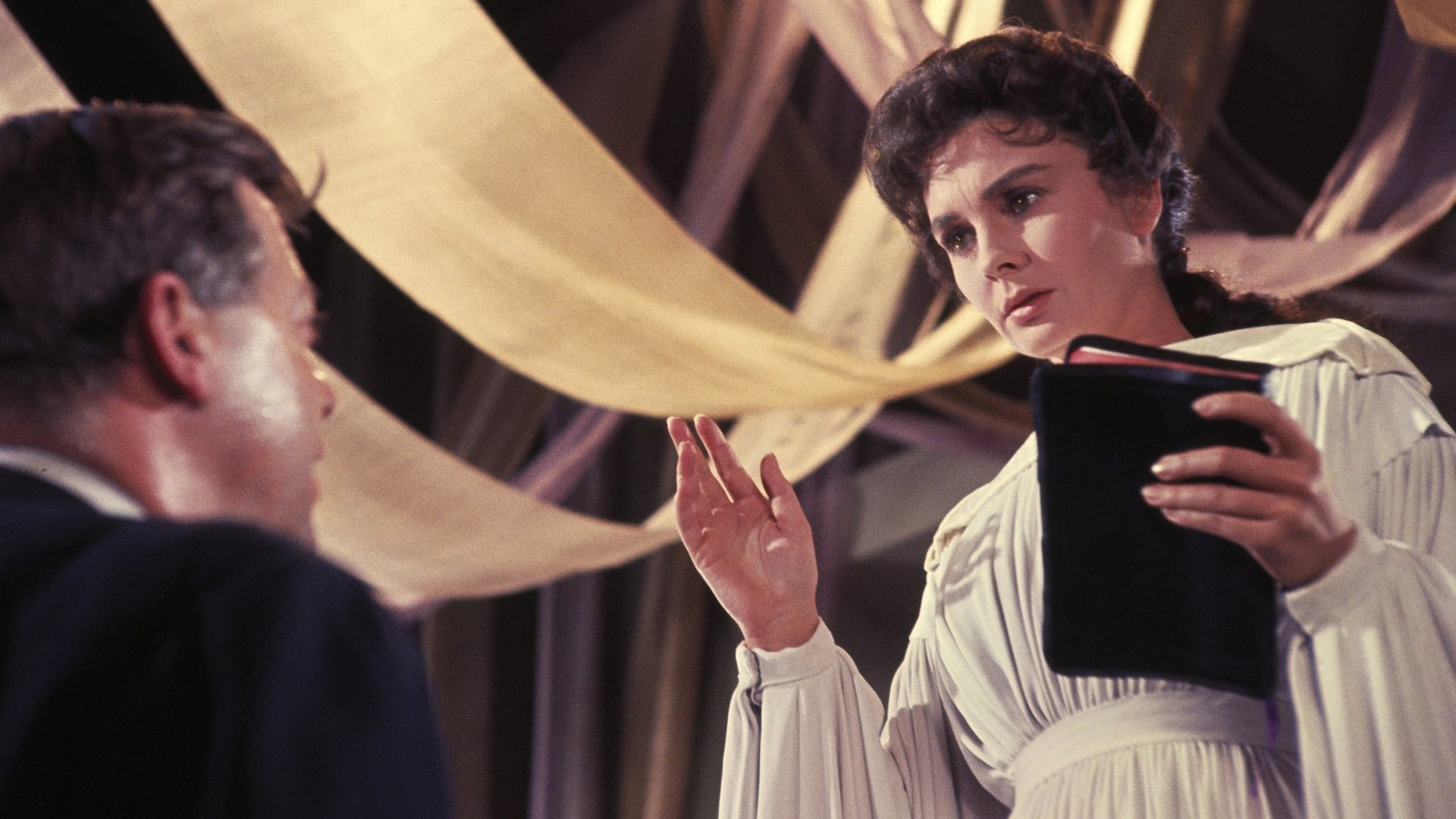 Cinematic background from Elmer Gantry 1960 - When hedonistic but charming con man Elmer Gantry meets the beautiful Sister Sharon Falconer, a roadside revivalist, he feigns piousness to join her act as a passionate preacher. The two make a successful onstage pair, and their chemistry extends to romance. Both the show and their relationship are threatened, however, when one of Gantry's ex-lovers decides that she has a score to settle with the charismatic performer.