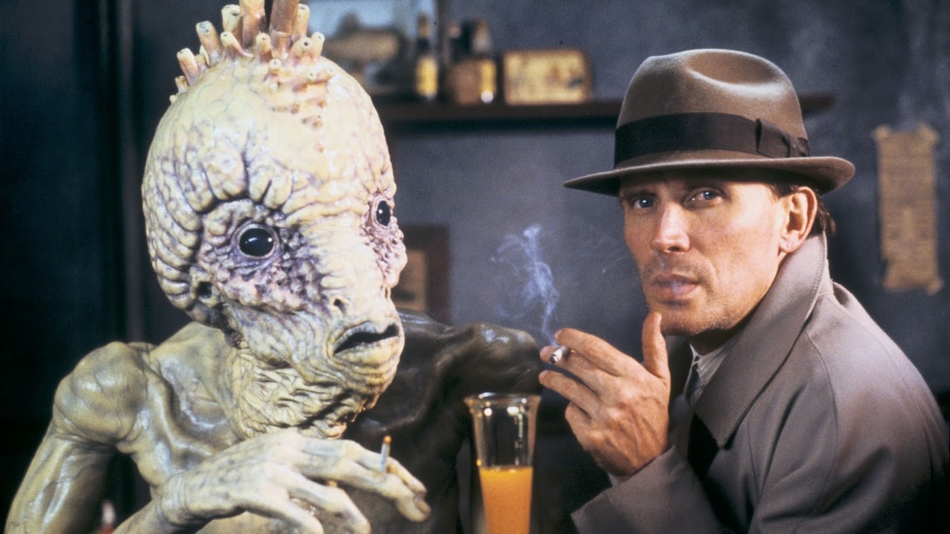 Cinematic background from Naked Lunch 1991 - Blank-faced bug killer Bill Lee and his dead-eyed wife, Joan, like to get high on Bill's pest poisons while lounging with Beat poet pals. After meeting the devilish Dr. Benway, Bill gets a drug made from a centipede. Upon indulging, he accidentally kills Joan, takes orders from his typewriter-turned-cockroach, ends up in a constantly mutating Mediterranean city and learns that his hip friends have published his work -- which he doesn't remember writing.