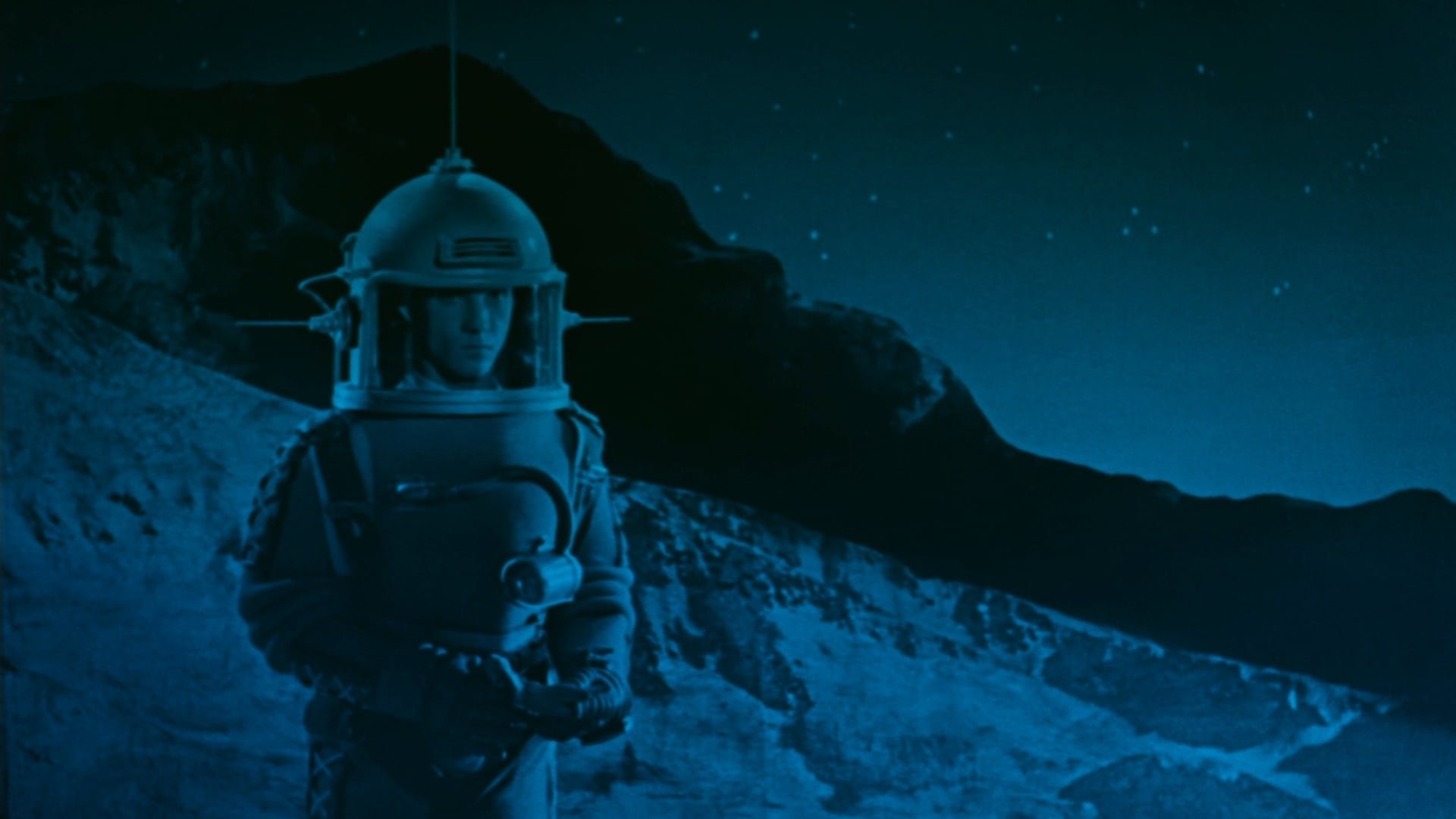 Cinematic background from The Fabulous Baron Munchausen 1962 - The 20th century's first man lands on the moon and discovers - that Baron Munchausen has already beaten him to it, along with Cyrano and characters from Jules Verne's lunar-landing novel.  The Baron spirits the young cosmonaut by horse-drawn ship back to an ancient "Earth", where they insult a sultan, rescue a princess, fall in love with the princess, and then as a trio have further experiences in a world of pastel colors, ornate dreamlike settings, and the inevitable angry disrupters of  peacefulness and love.