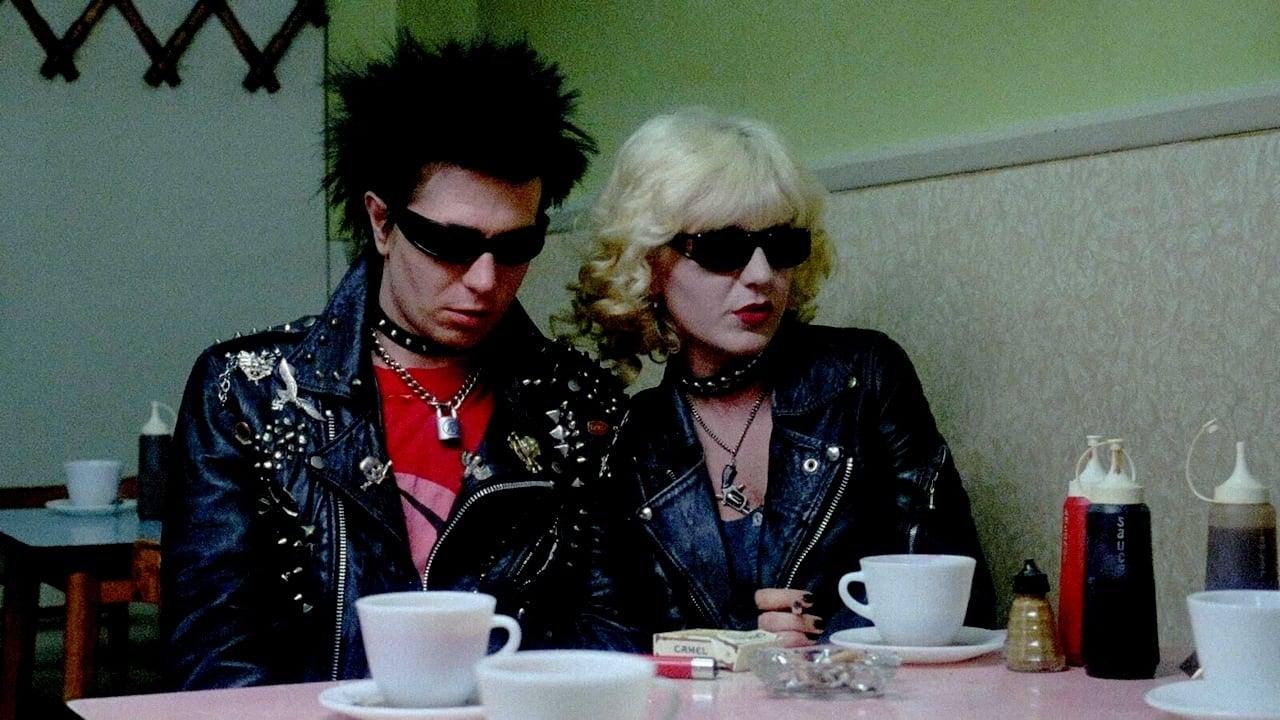 Cinematic background from Sid and Nancy 1986 - January 1978. After their success in England, the punk rock band Sex Pistols venture out on their tour of the southern United States. Temperamental bassist Sid Vicious is forced by his band mates to travel without his troubled girlfriend, Nancy Spungen, who will meet him in New York. When the band breaks up and Sid begins his solo career in a hostile city, the turbulent couple definitely falls into the depths of drug addiction.