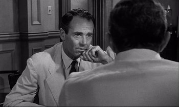 Movie still from “12 Angry Men” (1957), directed by Sidney Lumet – A man in a suit and tie looking at himself in the mirror; Close Up shot, Over the shoulder angle