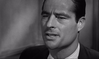 Movie still from “12 Angry Men” (1957), directed by Sidney Lumet – Black and white photograph of a man in a suit; Close Up shot, Over the shoulder angle