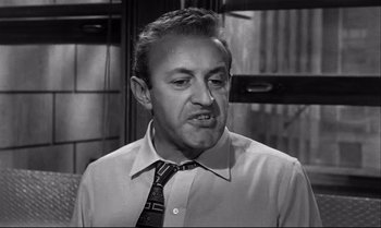 Movie still from “12 Angry Men” (1957), directed by Sidney Lumet – An old photo of a man in a dress shirt and a tie; Close Up shot, Low angle