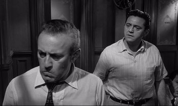 Movie still from “12 Angry Men” (1957), directed by Sidney Lumet – Two men are standing next to each other; Medium shot, Low angle