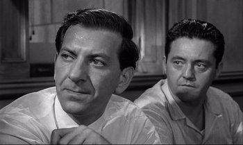 Movie still from “12 Angry Men” (1957), directed by Sidney Lumet – A black - and - white photo of a man and another man; Close Up shot, Over the shoulder angle