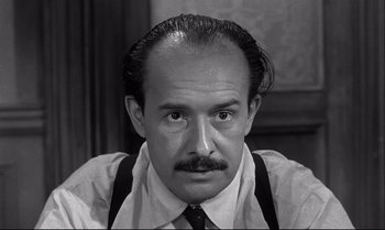 Movie still from “12 Angry Men” (1957), directed by Sidney Lumet – A black and white photo of a man with a mustache; Close Up shot, Low angle
