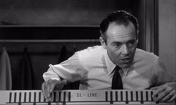 Movie still from “12 Angry Men” (1957), directed by Sidney Lumet – A black and white photo of a man playing a piano; Medium shot, Low angle
