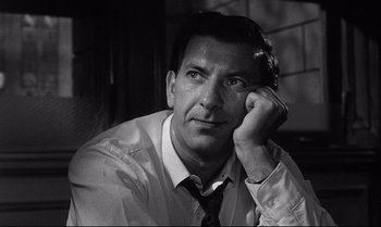 Movie still from “12 Angry Men” (1957), directed by Sidney Lumet – Black and white photograph of a man in a shirt and tie; Close Up shot, Low angle
