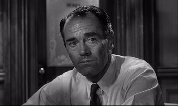 Movie still from “12 Angry Men” (1957), directed by Sidney Lumet – An old black and white photo of a man in a dress shirt and tie; Close Up shot, Low angle
