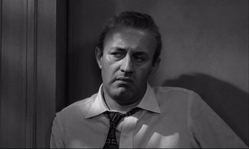 Movie still from “12 Angry Men” (1957), directed by Sidney Lumet – Black and white photograph of a man in a shirt and tie; Close Up shot, Over the shoulder angle