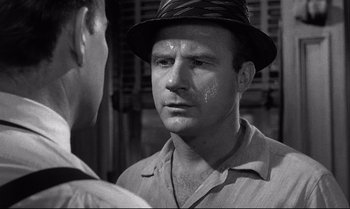 Movie still from “12 Angry Men” (1957), directed by Sidney Lumet – A black and white photo of a man with a hat on; Close Up shot, Over the shoulder angle