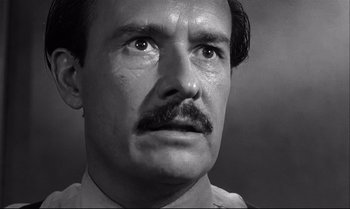 Movie still from “12 Angry Men” (1957), directed by Sidney Lumet – A man with a mustache looking up at the sky; Close Up shot, Low angle