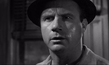 Movie still from “12 Angry Men” (1957), directed by Sidney Lumet – A black and white photo of a man with a hat on; Close Up shot, Low angle