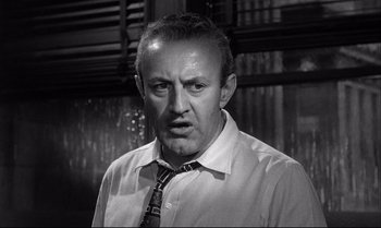 Movie still from “12 Angry Men” (1957), directed by Sidney Lumet – An older man wearing a neck tie and a white shirt; Close Up shot, Low angle