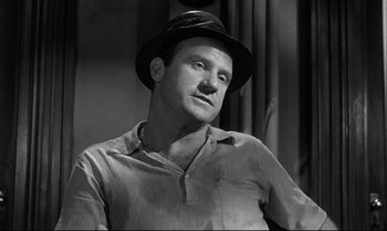 Movie still from “12 Angry Men” (1957), directed by Sidney Lumet – A black and white photo of a man wearing a hat; Close Up shot, Low angle