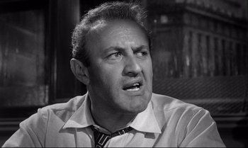 Movie still from “12 Angry Men” (1957), directed by Sidney Lumet – An older man in a shirt and a tie; Close Up shot, Low angle