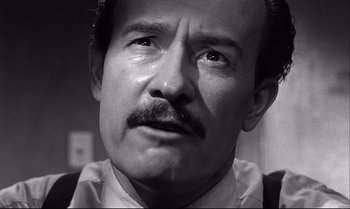 Movie still from “12 Angry Men” (1957), directed by Sidney Lumet – An old man with a mustache and a goatee; Close Up shot, Low angle