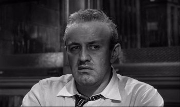 Movie still from “12 Angry Men” (1957), directed by Sidney Lumet – An older man wearing a shirt and a tie; Close Up shot, Low angle