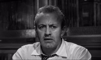 Movie still from “12 Angry Men” (1957), directed by Sidney Lumet – A man in a white shirt and a black tie; Close Up shot, Low angle