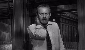 Movie still from “12 Angry Men” (1957), directed by Sidney Lumet – A black and white photo of a man in a tie; Close Up shot, Low angle