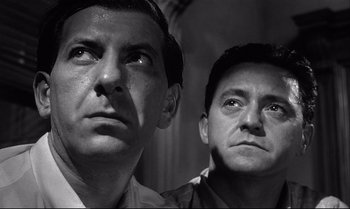 Movie still from “12 Angry Men” (1957), directed by Sidney Lumet – A black - and - white photo of two men standing next to each other; Close Up shot, Low angle