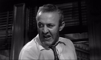 Movie still from “12 Angry Men” (1957), directed by Sidney Lumet – A man in a white dress shirt and a black tie; Close Up shot, Low angle