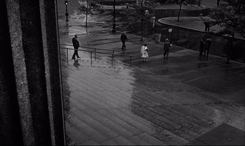 Movie still from “12 Angry Men” (1957), directed by Sidney Lumet – A group of people walking down a sidewalk; Extreme Wide shot, High angle