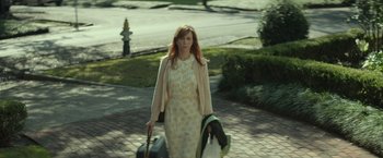 Movie still from “Hateship Loveship” (2013), directed by Liza Johnson – A woman walking down the street with her luggage; Medium shot, Over the shoulder angle