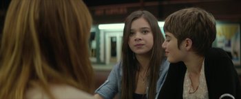 Movie still from “Hateship Loveship” (2013), directed by Liza Johnson – A group of young people sitting around a table; Close Up shot, Over the shoulder angle