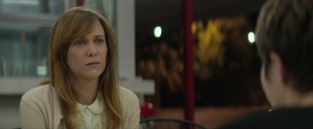 Movie still from “Hateship Loveship” (2013), directed by Liza Johnson – A person sitting at a table; Close Up shot, Over the shoulder angle